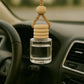 Car air freshener with wooden beads hanging from a car's rearview mirror.